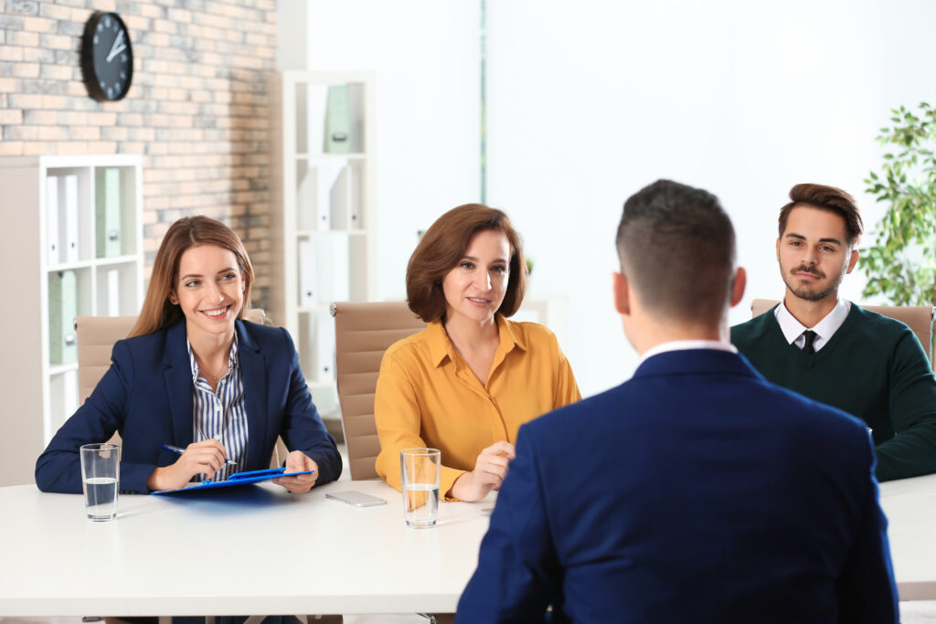 A team of hiring managers interviewing a job applicant.